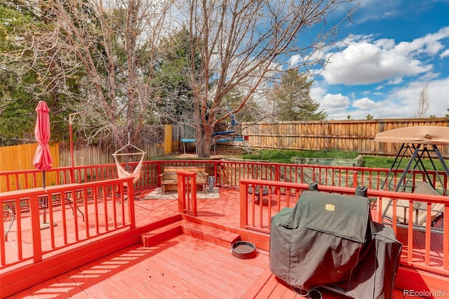 10059 Granite Hill Dr, Parker, CO 80134 - wooden terrace with a fenced backyard, area for grilling, and a trampoline