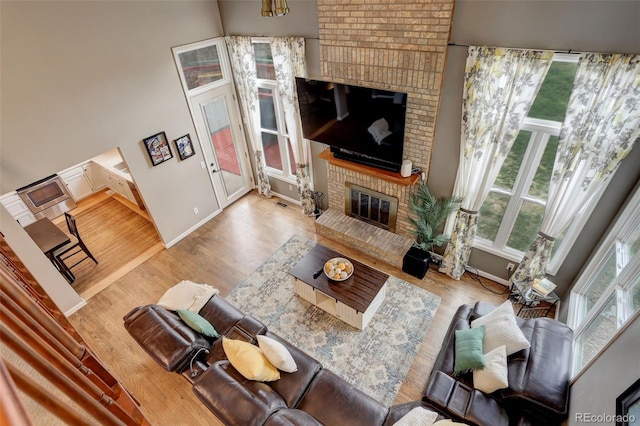10059 Granite Hill Dr, Parker, CO 80134 - living room featuring a fireplace, baseboards, visible vents, and wood finished floors