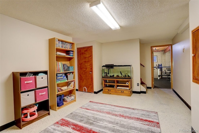 10059 Granite Hill Dr, Parker, CO 80134 - playroom featuring baseboards, speckled floor, and a textured ceiling