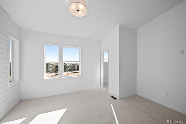 unfurnished room with light colored carpet