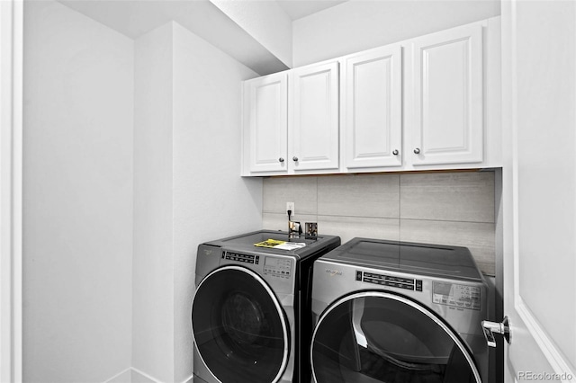 laundry area with cabinets and separate washer and dryer