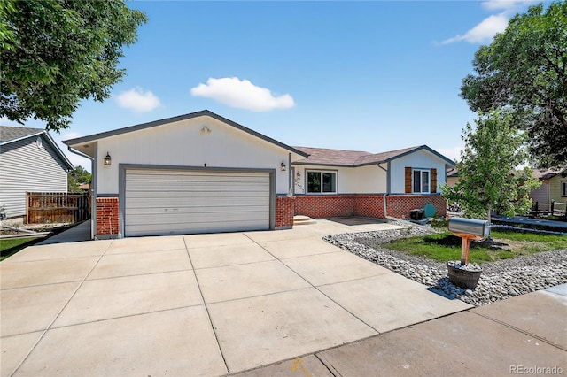 8721 W 86th Ave, Arvada, CO 80005 - ranch-style home featuring brick siding, an attached garage, and driveway