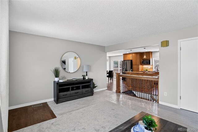 8721 W 86th Ave, Arvada, CO 80005 - living room featuring a textured ceiling and wood finished floors