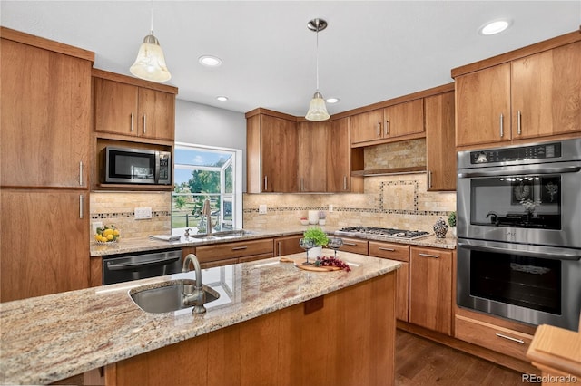8721 W 86th Ave, Arvada, CO 80005 - kitchen with stainless steel appliances, brown cabinetry, backsplash, and recessed lighting