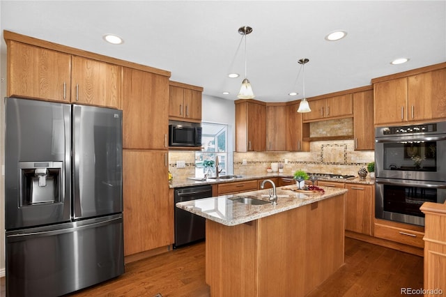 8721 W 86th Ave, Arvada, CO 80005 - kitchen with stainless steel appliances, decorative backsplash, brown cabinetry, light stone countertops, and recessed lighting