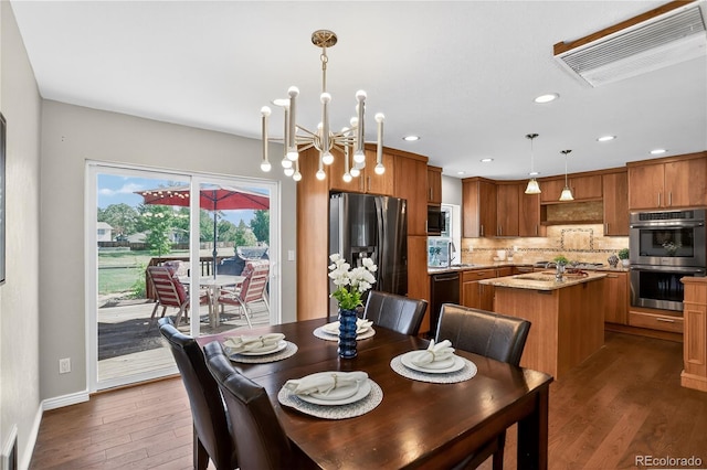 8721 W 86th Ave, Arvada, CO 80005 - dining area with dark wood-type flooring, recessed lighting, and a chandelier