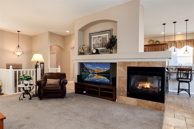 sitting room featuring a fireplace and light carpet