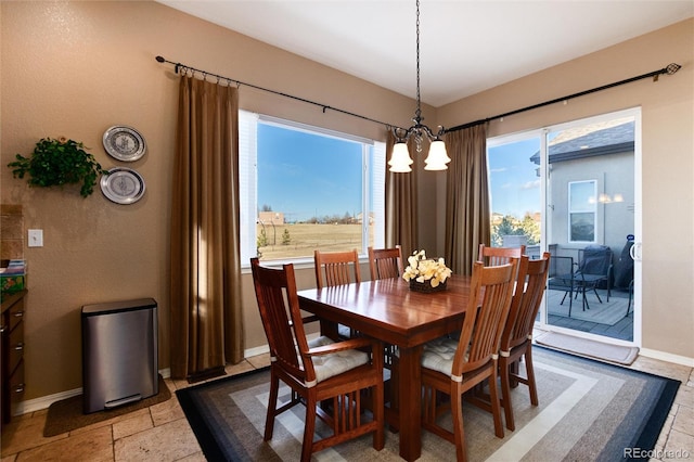 dining space featuring a notable chandelier