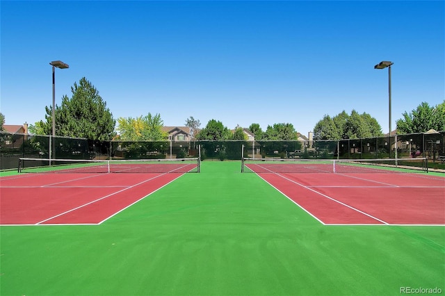 view of tennis court featuring basketball hoop