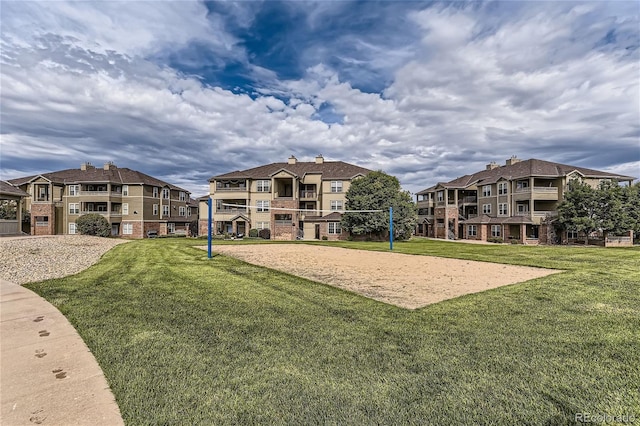 view of home's community with a yard and volleyball court