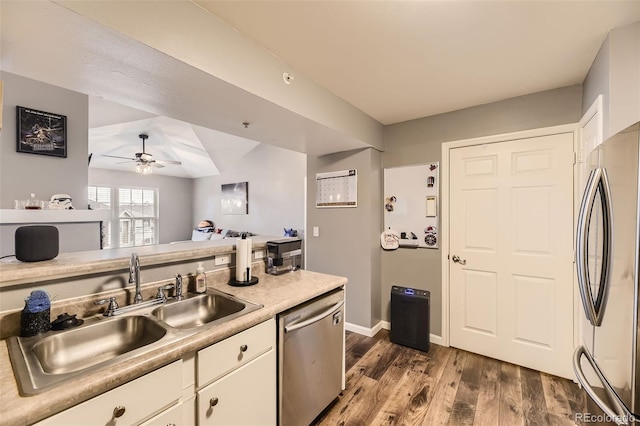 kitchen featuring ceiling fan, appliances with stainless steel finishes, white cabinets, and sink