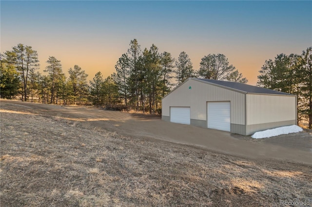 view of garage at dusk