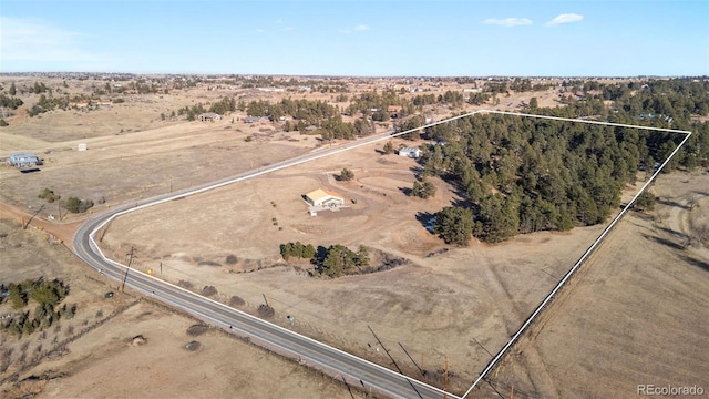 birds eye view of property with a rural view