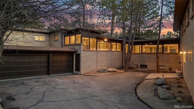 property exterior at dusk featuring a garage