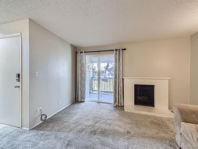 unfurnished living room featuring carpet floors, a fireplace, baseboards, and a textured ceiling