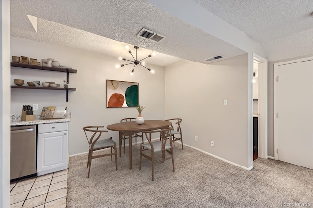 dining room featuring a textured ceiling, visible vents, a notable chandelier, and light colored carpet