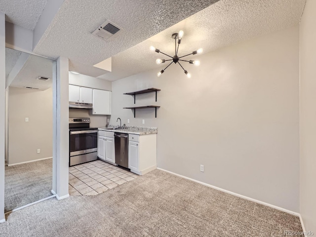 kitchen featuring appliances with stainless steel finishes, light colored carpet, visible vents, and under cabinet range hood