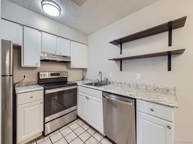 kitchen with appliances with stainless steel finishes, under cabinet range hood, white cabinetry, open shelves, and a sink