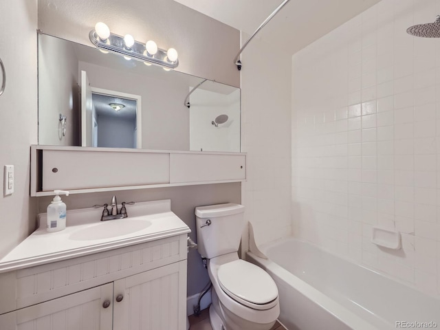 bathroom with washtub / shower combination, vanity, and toilet