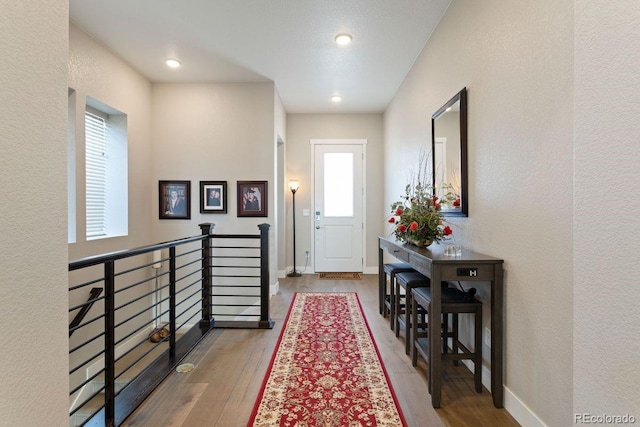 7022 Homeplace St, Castle Rock, CO 80108 - foyer entrance with plenty of natural light, wood finished floors, a textured wall, and baseboards