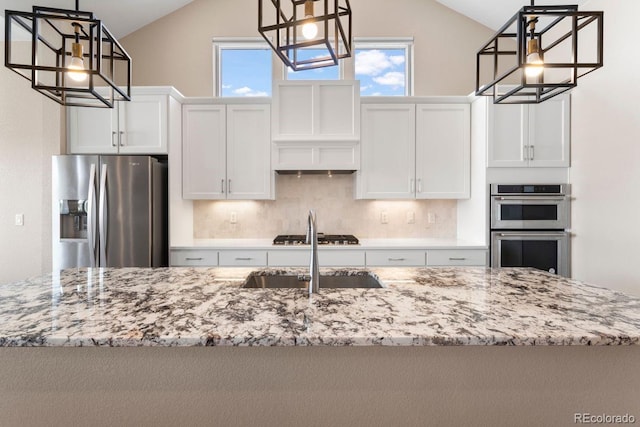 7022 Homeplace St, Castle Rock, CO 80108 - kitchen featuring appliances with stainless steel finishes, lofted ceiling, decorative backsplash, a sink, and light stone counters