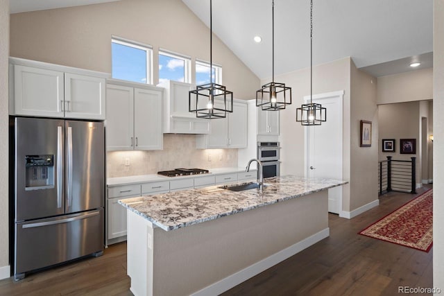 7022 Homeplace St, Castle Rock, CO 80108 - kitchen featuring appliances with stainless steel finishes, a sink, high vaulted ceiling, white cabinets, and dark wood-type flooring