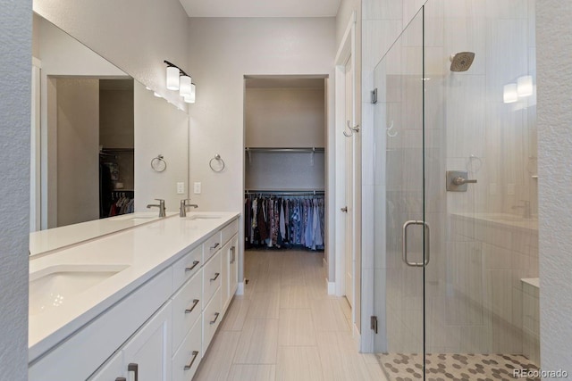 7022 Homeplace St, Castle Rock, CO 80108 - bathroom with a shower stall, a walk in closet, and double vanity