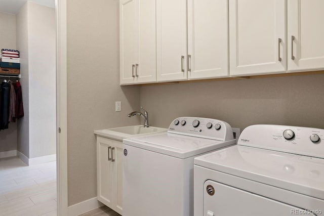 7022 Homeplace St, Castle Rock, CO 80108 - washroom with separate washer and dryer, cabinet space, baseboards, and light wood-style flooring