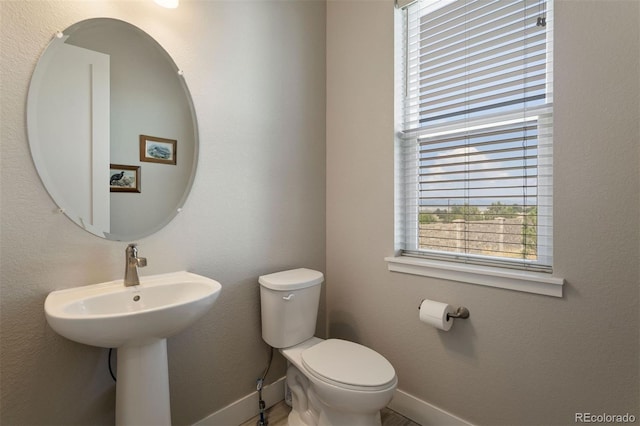 7022 Homeplace St, Castle Rock, CO 80108 - half bathroom featuring baseboards, toilet, and a sink