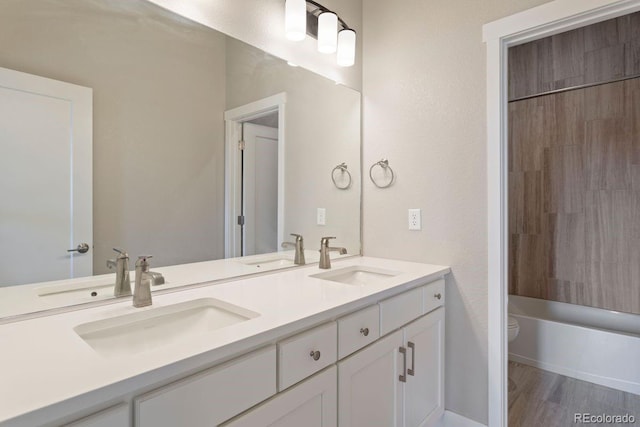 7022 Homeplace St, Castle Rock, CO 80108 - bathroom with toilet, double vanity, and wood finished floors