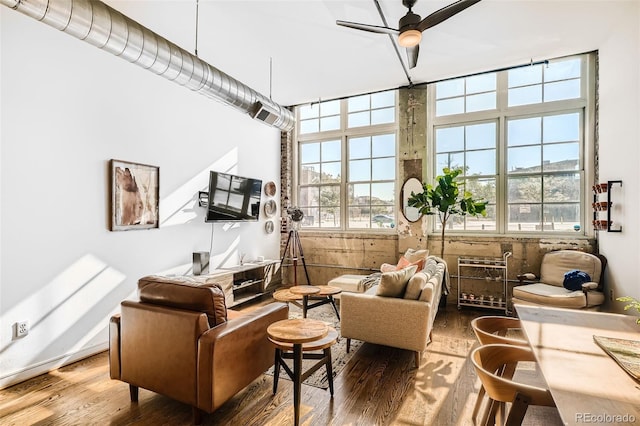 living room featuring ceiling fan, hardwood / wood-style flooring, and a wealth of natural light