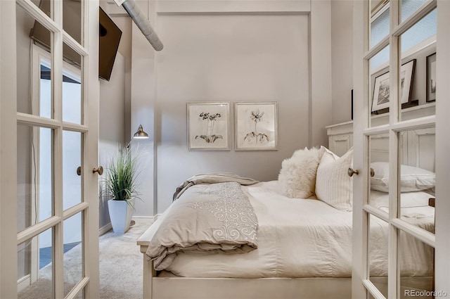 bedroom with a high ceiling and carpet floors