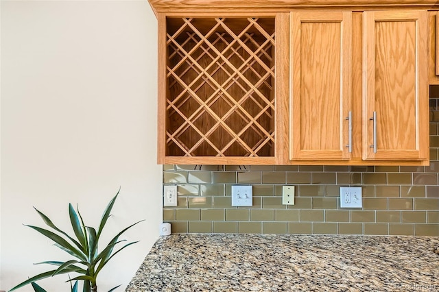 details featuring decorative backsplash and light stone countertops