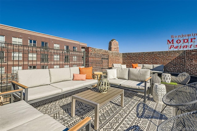 view of patio / terrace with a balcony and an outdoor living space