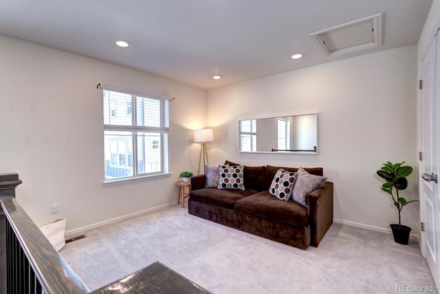 carpeted living area with baseboards, recessed lighting, visible vents, and attic access