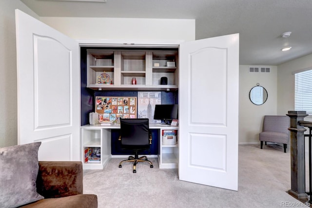 carpeted office with baseboards and visible vents