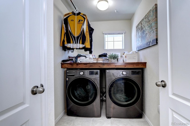 washroom featuring tile patterned flooring, laundry area, independent washer and dryer, and baseboards