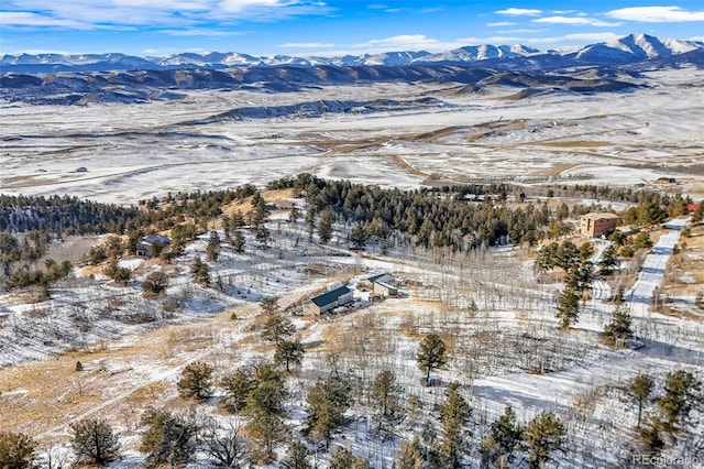 snowy aerial view with a mountain view