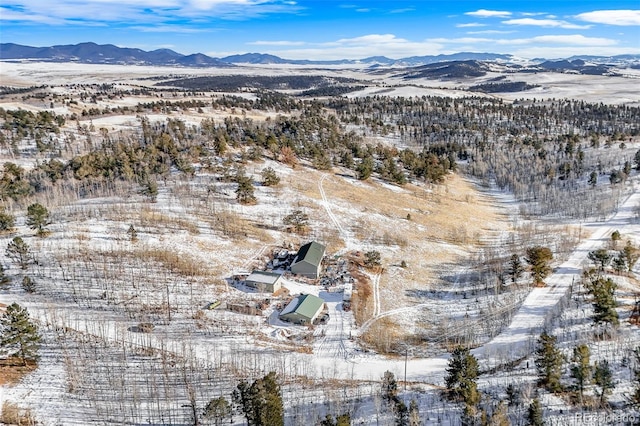 snowy aerial view with a mountain view