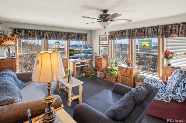 living room featuring a wealth of natural light and ceiling fan