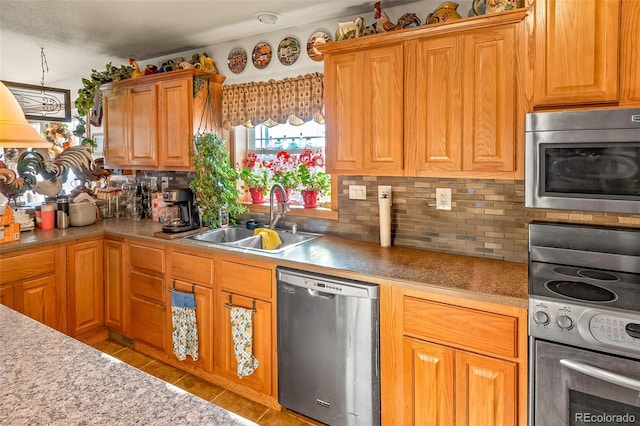 kitchen with tasteful backsplash, appliances with stainless steel finishes, and sink