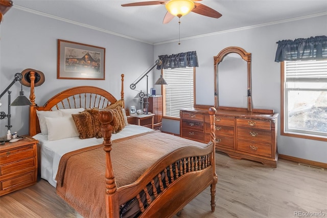 bedroom with crown molding, ceiling fan, and light hardwood / wood-style flooring