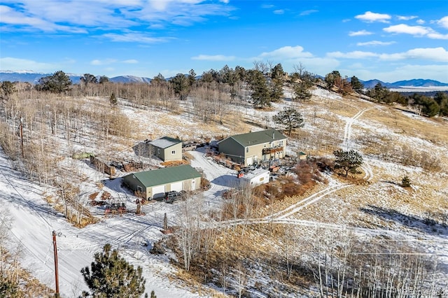 snowy aerial view with a mountain view