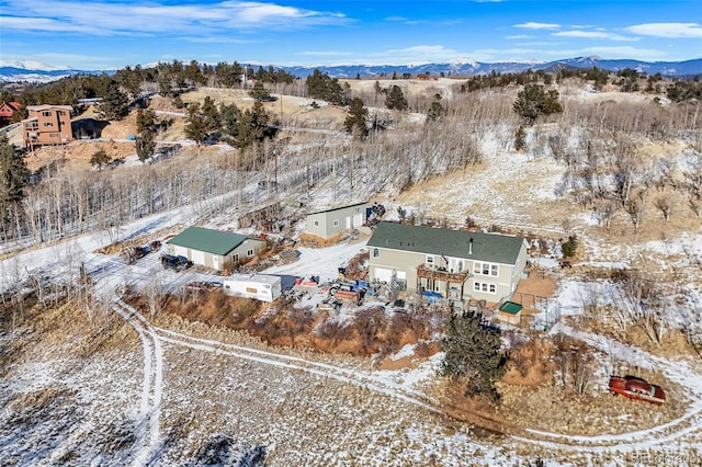 snowy aerial view featuring a mountain view