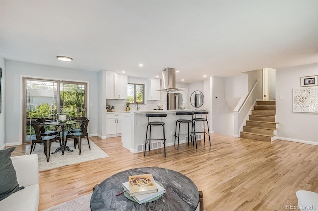 9345 W Iowa Pl, Lakewood, CO 80232 - living area featuring stairs, light wood-type flooring, baseboards, and recessed lighting