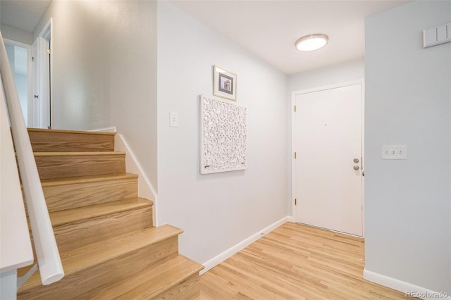9345 W Iowa Pl, Lakewood, CO 80232 - entryway with stairs, light wood finished floors, and baseboards