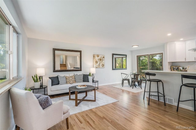 9345 W Iowa Pl, Lakewood, CO 80232 - living room with light wood finished floors, baseboards, and recessed lighting