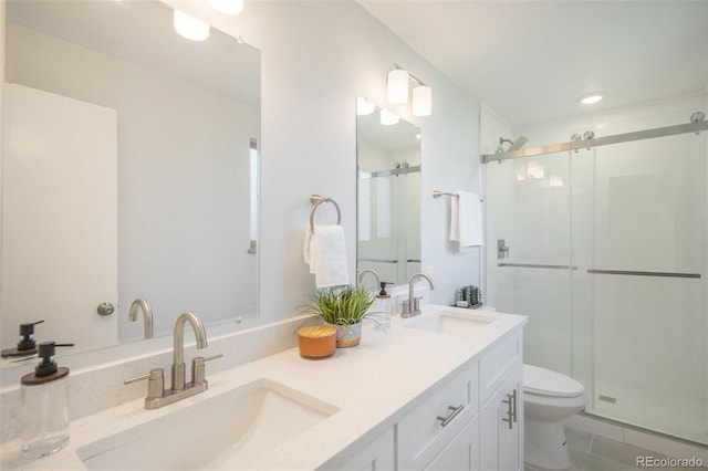 9345 W Iowa Pl, Lakewood, CO 80232 - full bathroom featuring toilet, double vanity, a shower stall, tile patterned floors, and recessed lighting