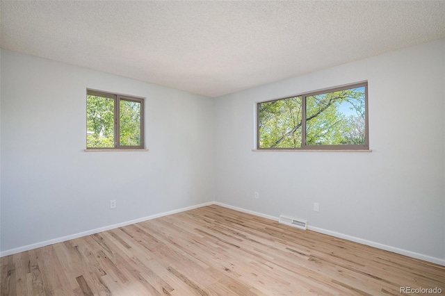 9345 W Iowa Pl, Lakewood, CO 80232 - empty room featuring wood finished floors, baseboards, and a textured ceiling