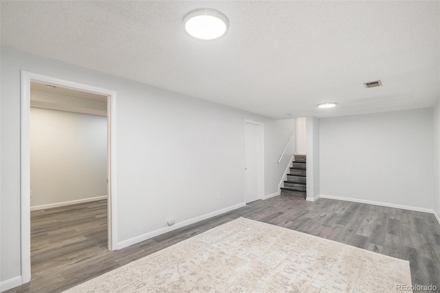 9345 W Iowa Pl, Lakewood, CO 80232 - finished basement with stairs, wood finished floors, a textured ceiling, and baseboards